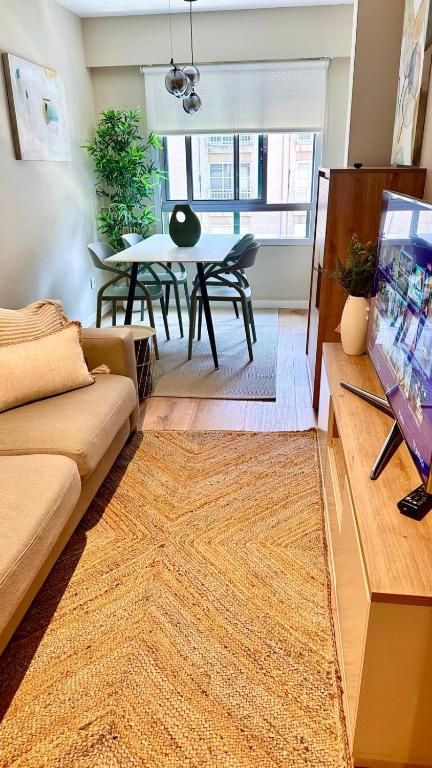 a living room with a couch and a dining room table at Alegría 2 in Amés