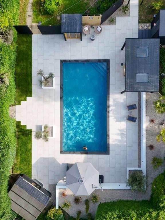 an overhead view of a swimming pool in a backyard at Serenity Villa in Beccles