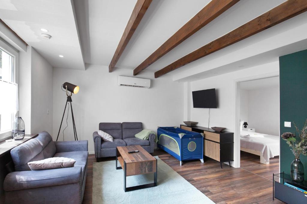 a living room with a couch and a tv at Naturparadies an der Saale in Könnern