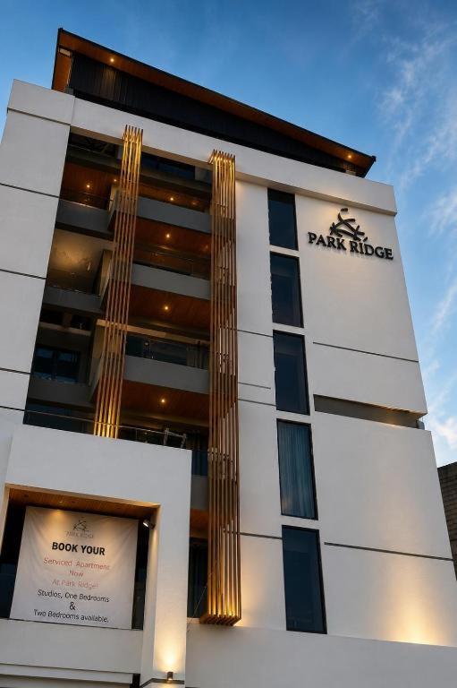 a building with a sign on the side of it at LMY Boutique Prestige Hotel Apartments - Murree Monal Expressway in Murree