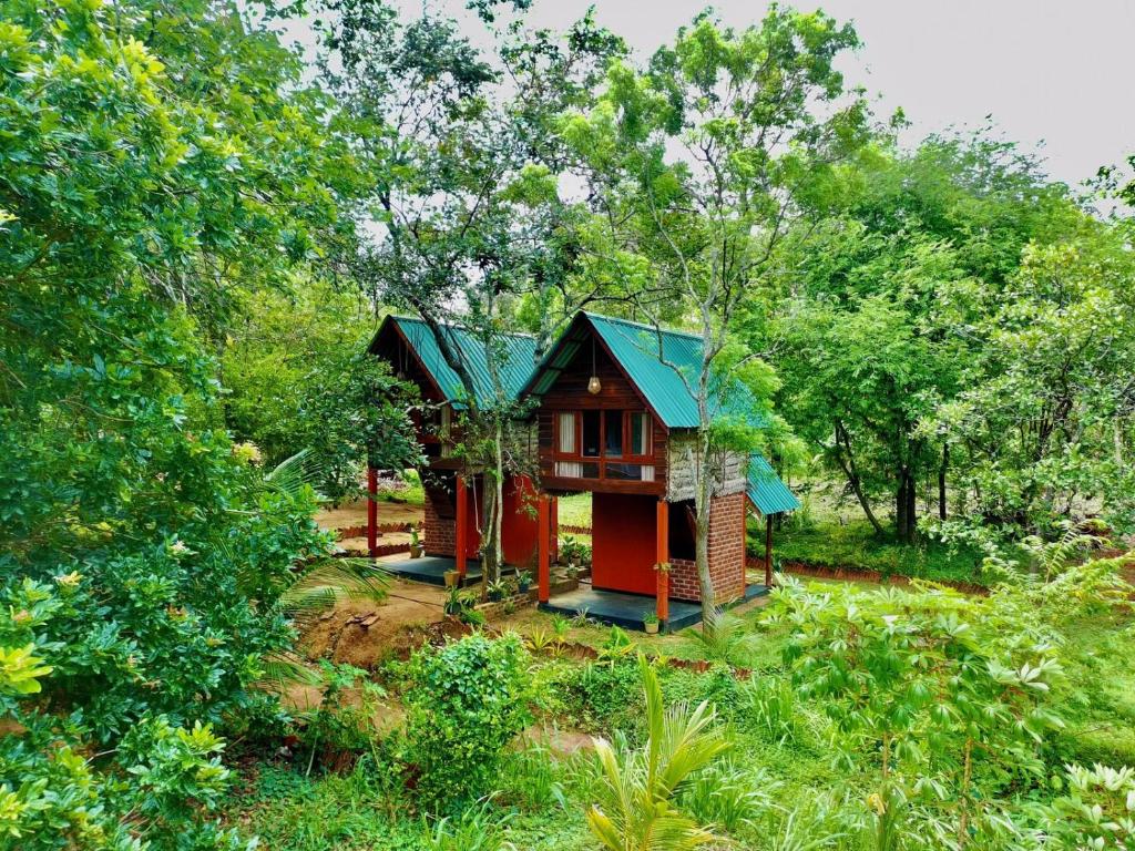 a small house in the middle of a forest at Mango Tree Villa in Sigiriya