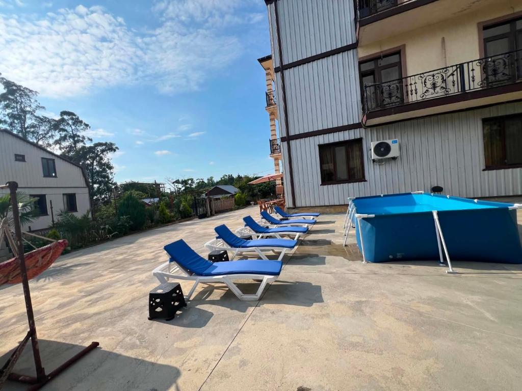 a row of lounge chairs and a pool table at vila in CHAKVI in Chakvi