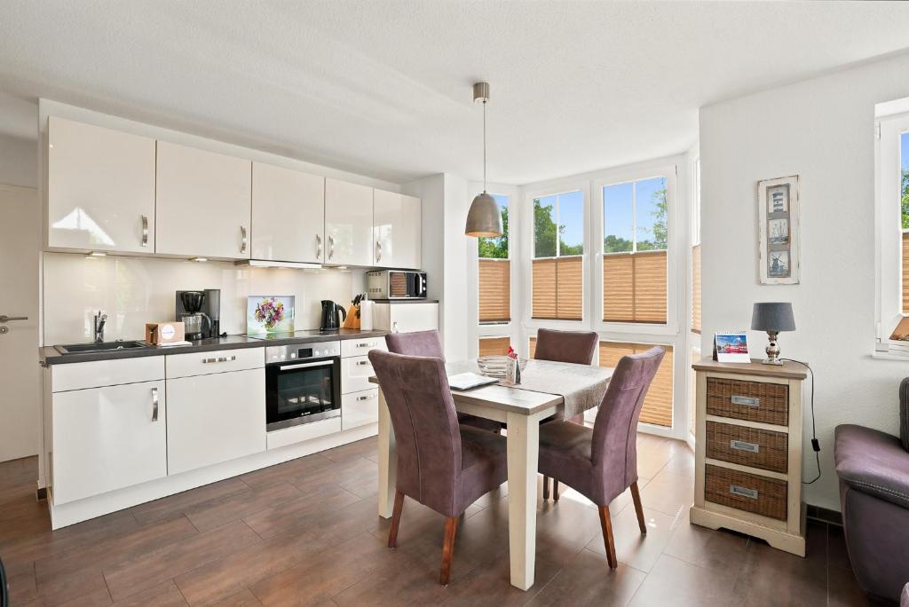 a kitchen and dining room with a table and chairs at Amelie in Greetsiel