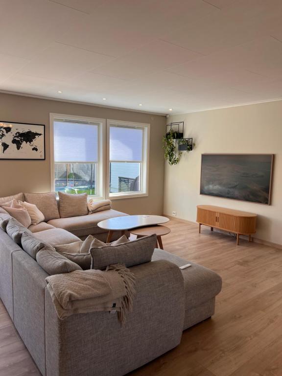 a living room with a couch and a table at Flott hus på Tasta in Stavanger