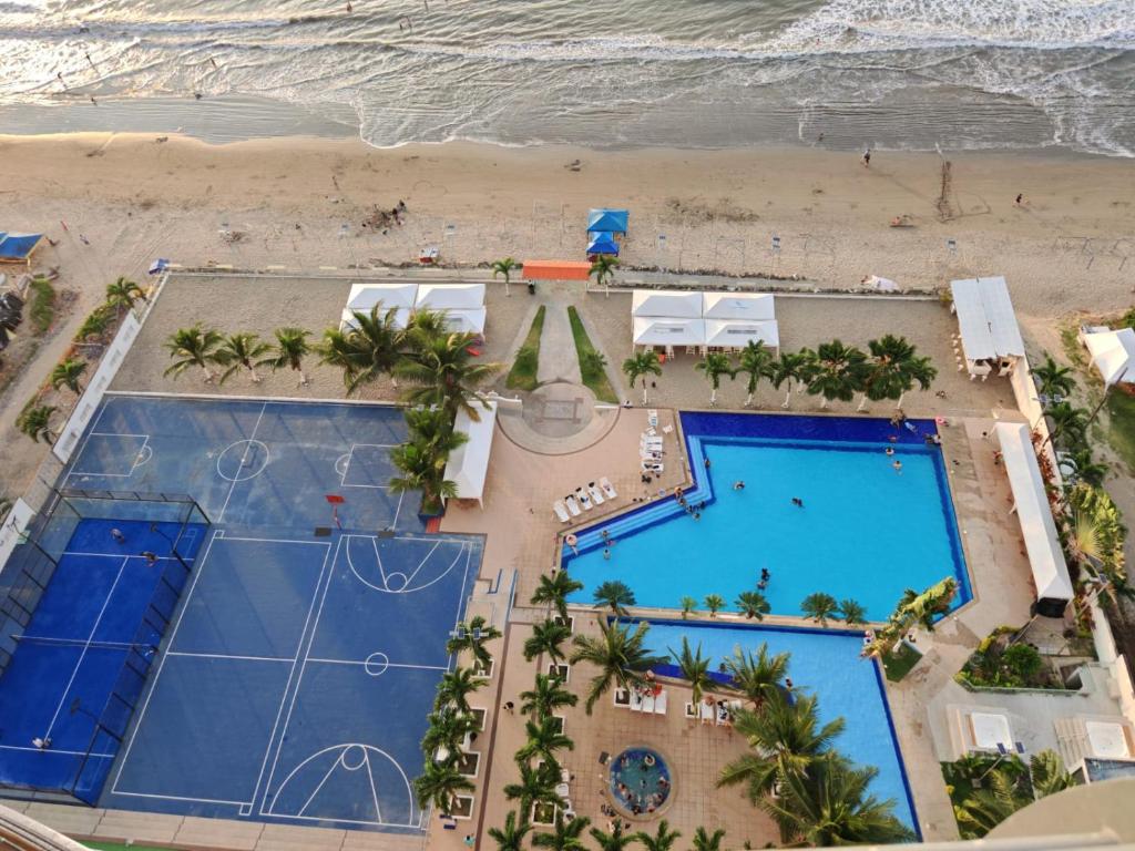 an overhead view of the beach and swimming pools at the resort at fontaine bleau piso 4F in Atacames