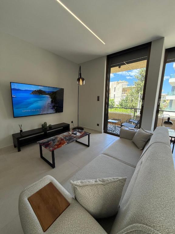 a living room with a couch and a tv at Notos Suites in Athens