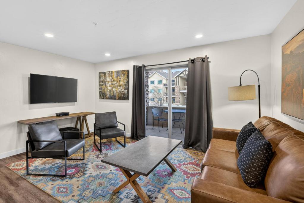 a living room with a couch and a table at Moab RedCliff Condos in Moab