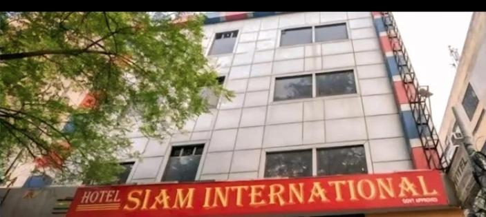 a tall white building with a sign in front of it at Hotel Siam International Karol Bagh New Delhi in New Delhi