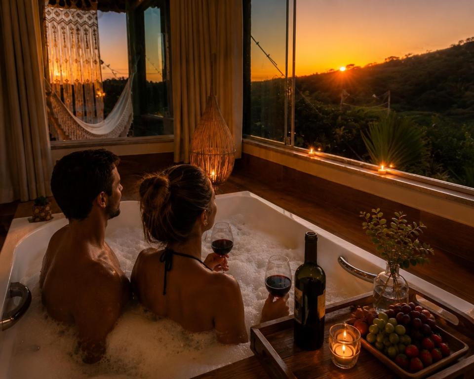 a man and woman sitting in a bath tub watching the sunset at Loft Mandalua in Serra do Cipo