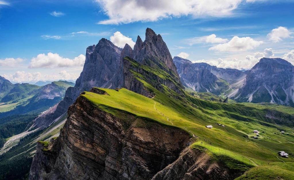 a mountain with green grass on top of it at Dolomites Apartment Christian in Ortisei