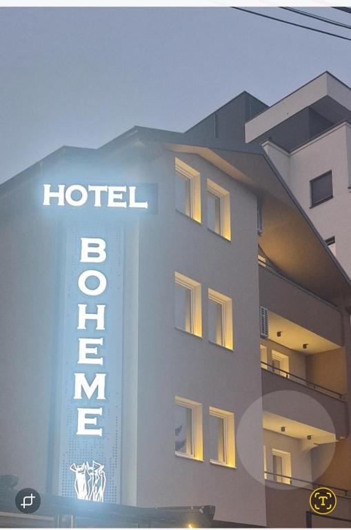 a hotel building with a sign in front of it at Hotel Boheme in Peje