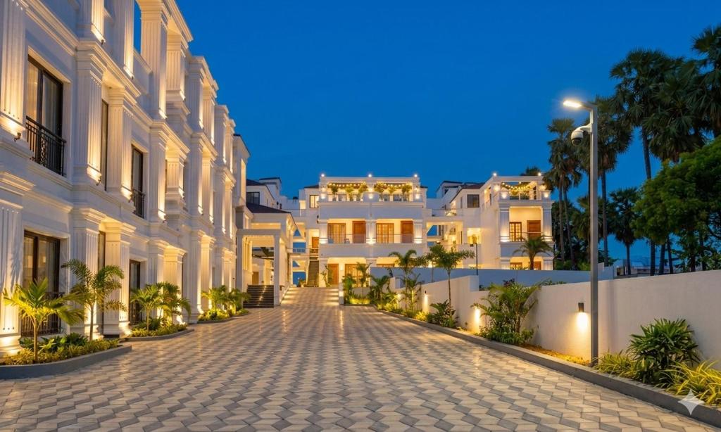 a cobblestone street in front of a white building at PSR Coral Resorts, 800m Away from Rameswaram Temple in Rāmeswaram
