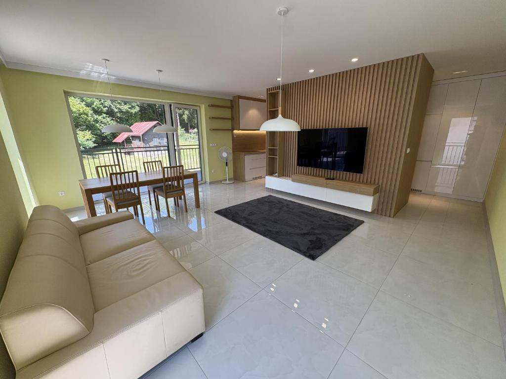 a living room with a couch and a dining room at Belvedere Luxury Suite in Bojnice