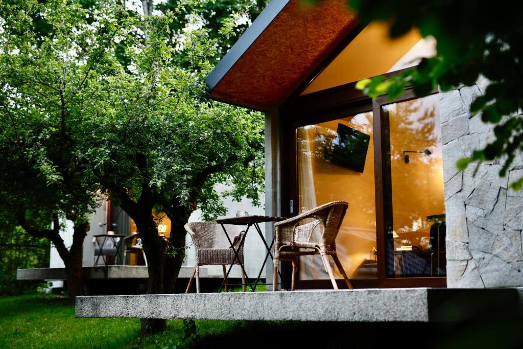a patio with two chairs and a table on a porch at Letnisko Polańczyk in Polańczyk