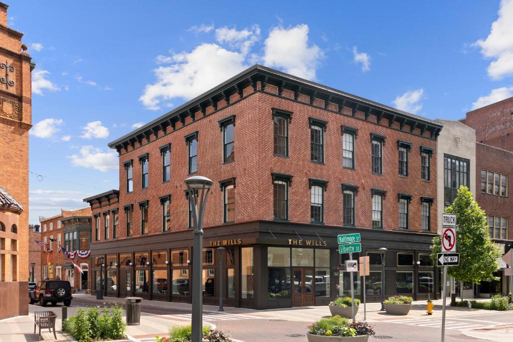 a large brick building on a street corner at The Wills Hotel in Cumberland