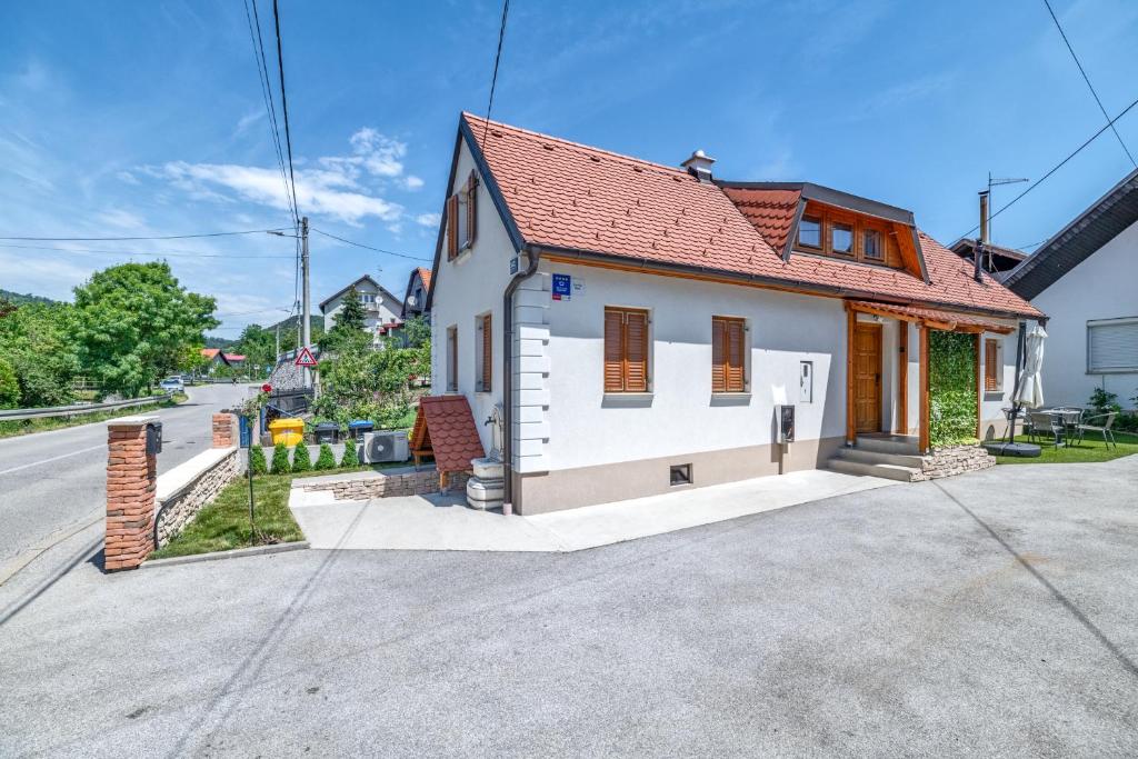 a small white house with a red roof at House Majda in Zagreb