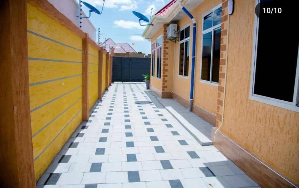 an empty alleyway between two buildings in a building at Vancovuer homes in Dodoma