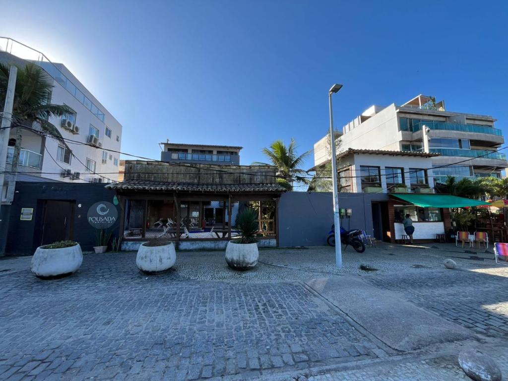 a cobblestone street with benches in front of a building at Pousada Pontal RJ in Rio de Janeiro