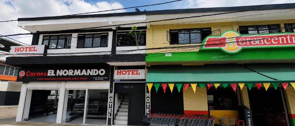 a store front of a building on a street at Hotel Bachue Ibagué in Ibagué