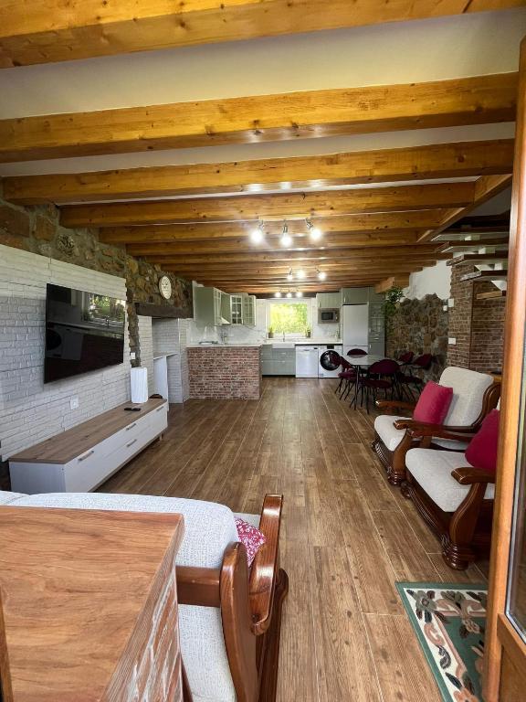 a large room with wooden ceilings and a living room at Casa CABAÑA in Riaño