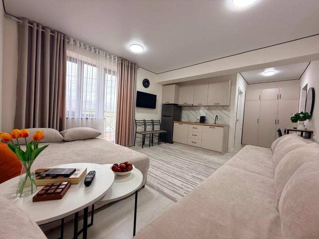 a living room with a couch and a table at Семейные номера с ванной, кухней в Яхт Виллидж Чолпон-Ата in Cholpon-Ata