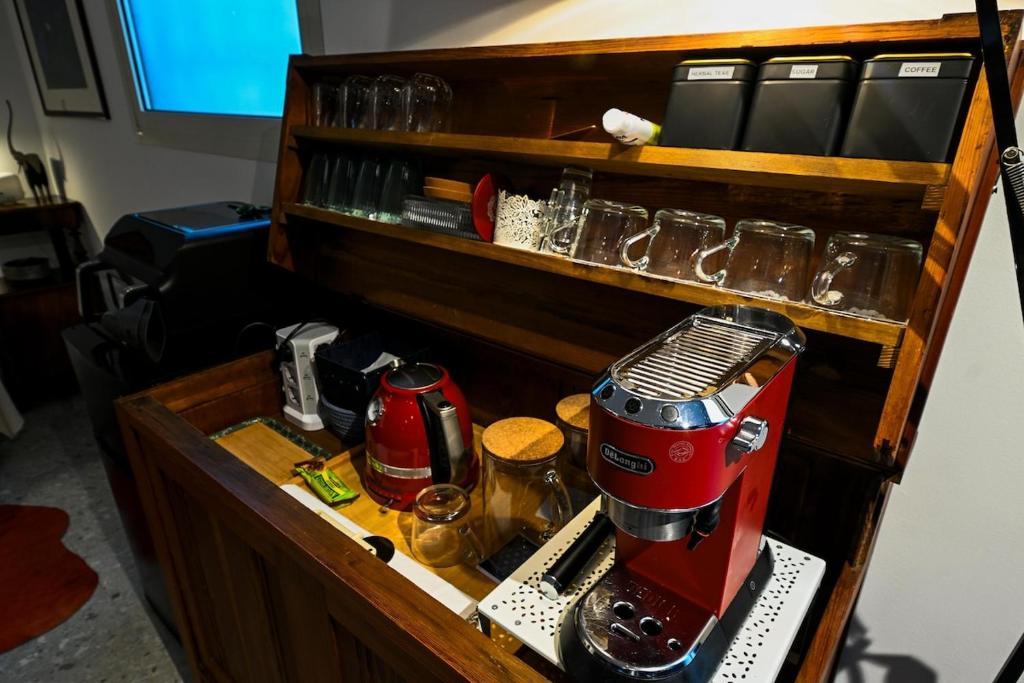 a red mixer sitting on top of a wooden shelf at BluePrivateSpa in Latte