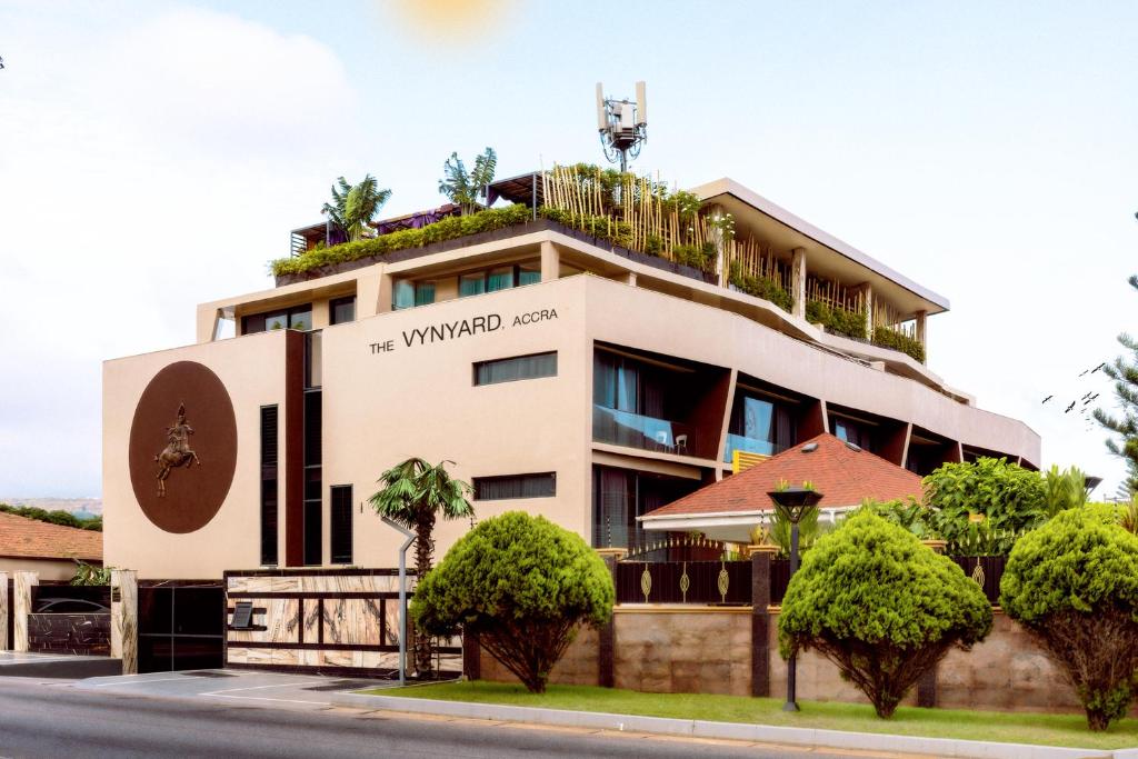 a building with trees in front of it at The Vynyard, Accra in Accra