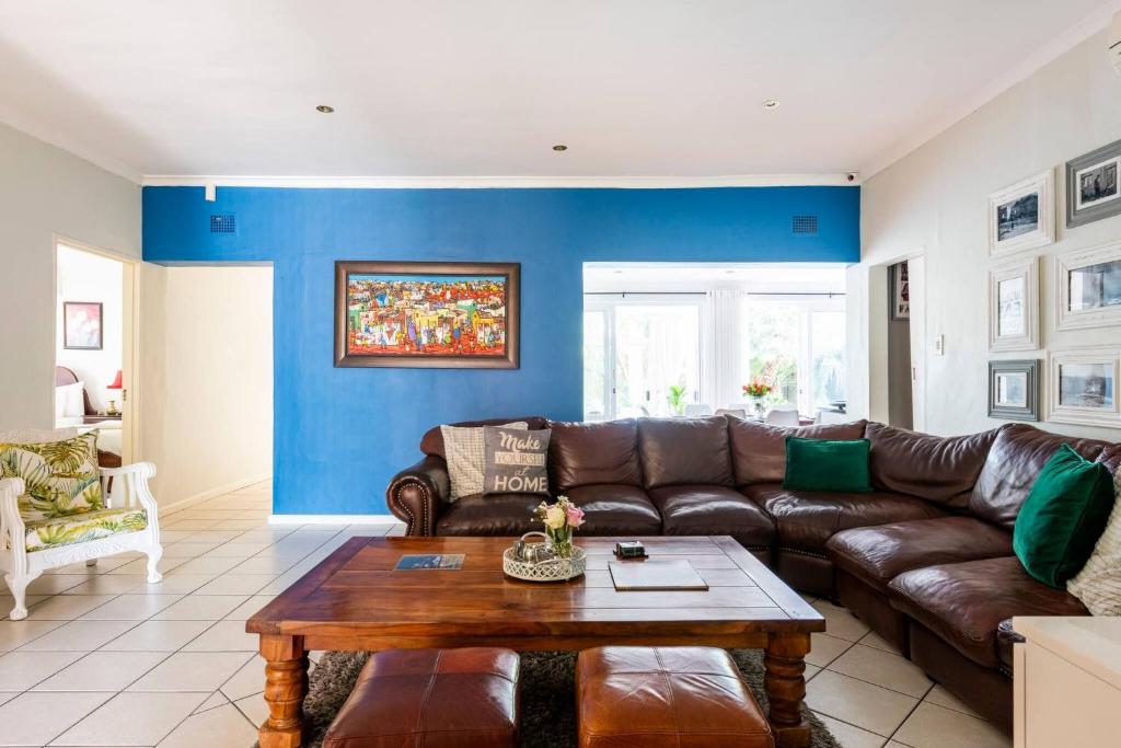 a living room with a couch and a table at Your homely experience in Paarl