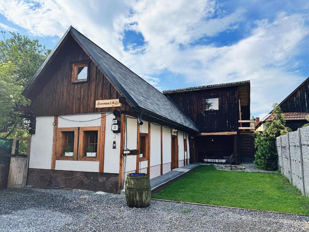 a small house with a black and white at Drevenica M&P 2 in Bešeňová