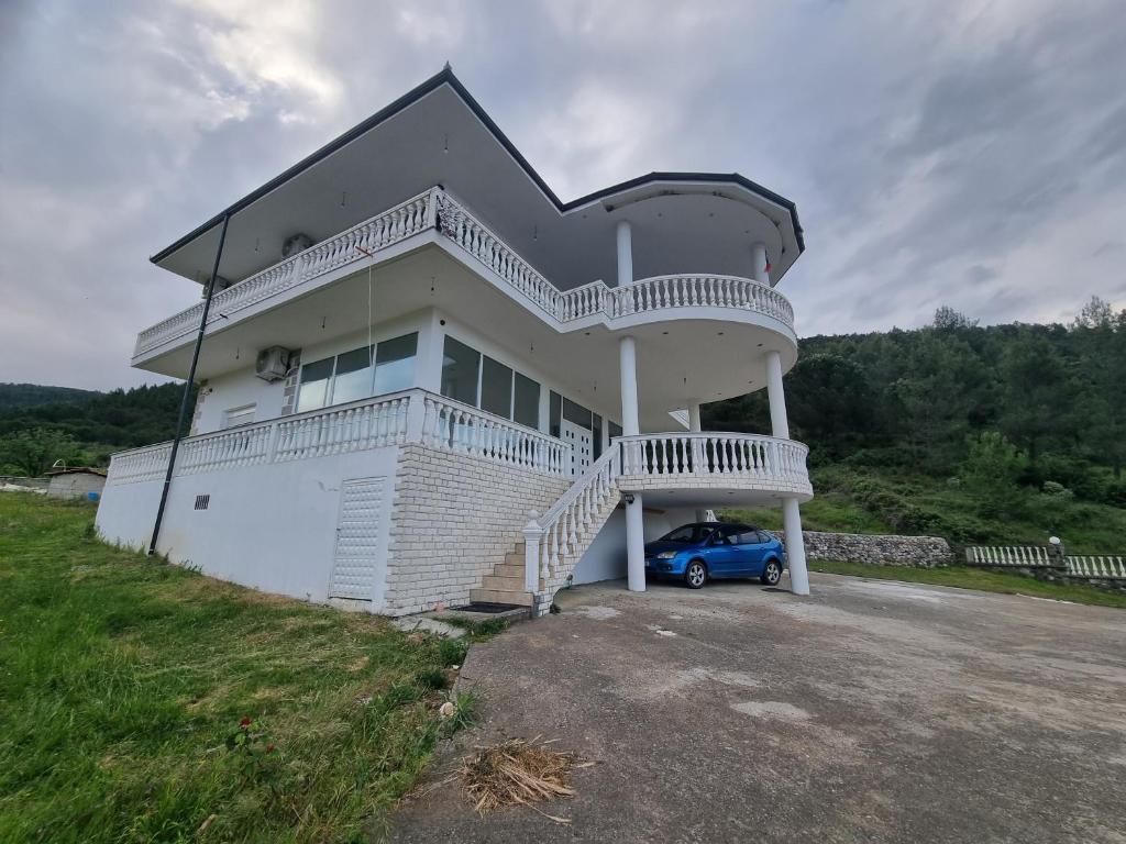 a house with a car parked in front of it at Kalanar villa in Elbasan