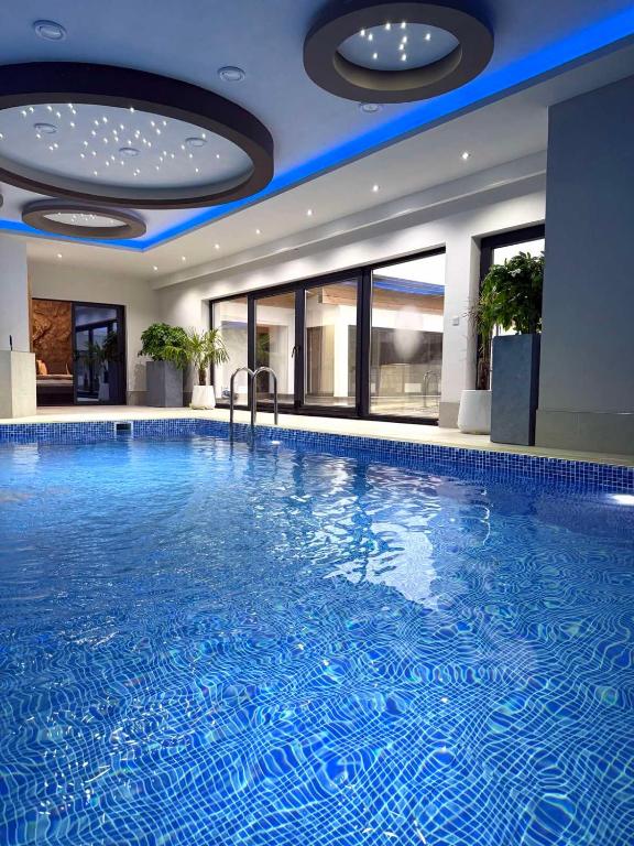a large swimming pool in a hotel room at Villa Prestiž in Sokolac