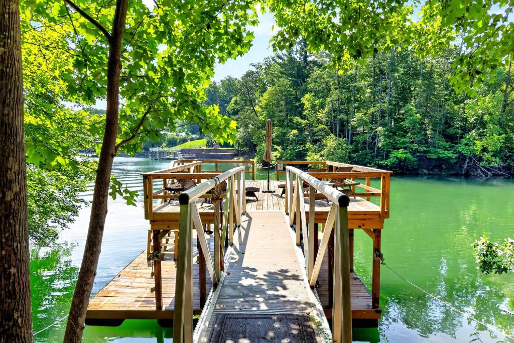 a wooden bridge over a lake with trees at Calm Water Cove in Nebo