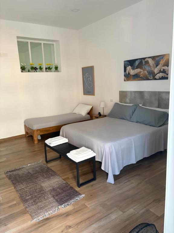 a bedroom with a large bed and a table at Carpenters Guest House in Pompei