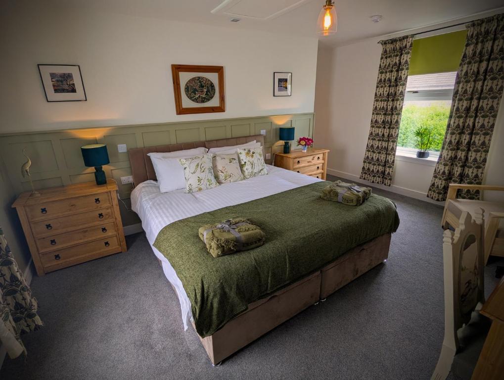 a bedroom with a bed with two towels on it at The Wigtown Ploughman in Wigtown