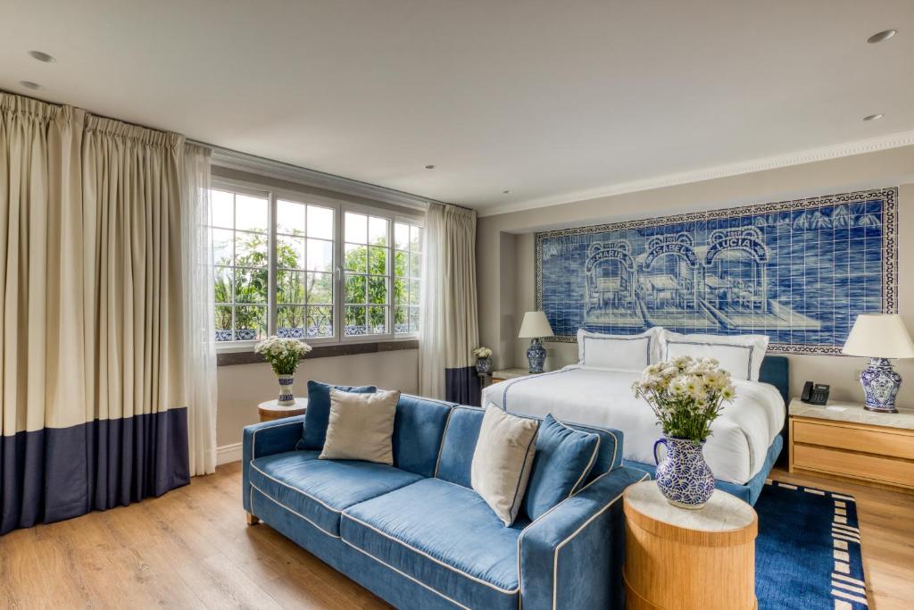 a bedroom with a bed and a blue couch at Casa Talavera by Tasman in Mexico City