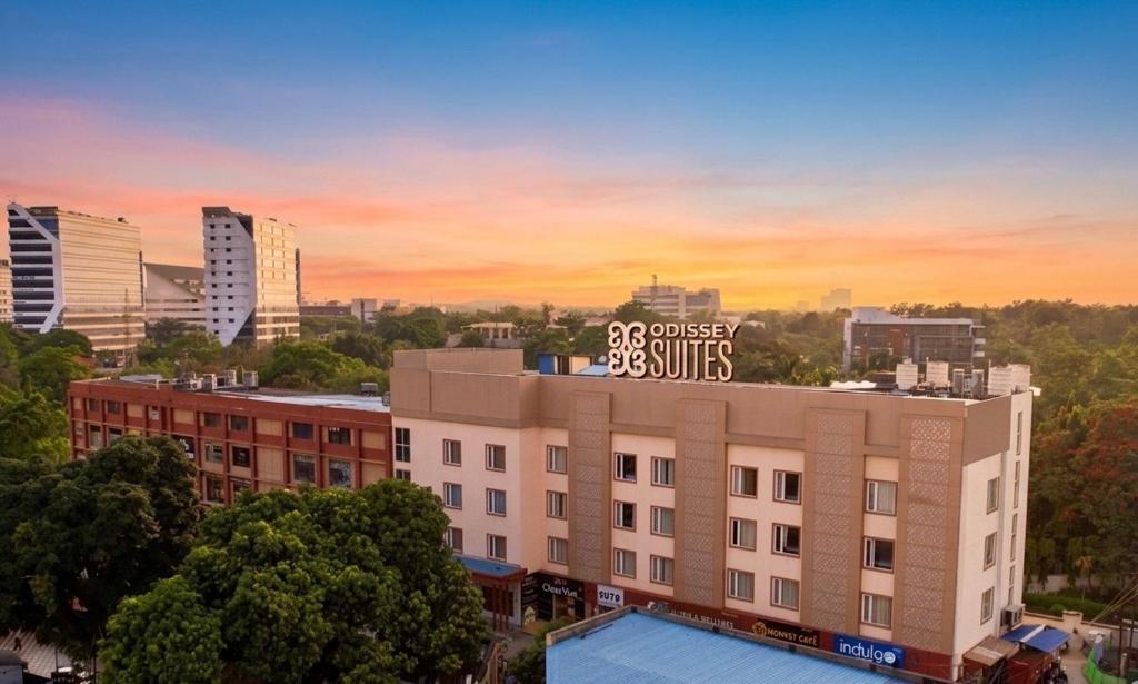 a building with a sign on the top of it at Odissey Suites in Bhubaneshwar