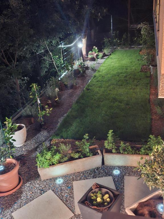 a garden at night with plants and lights at Apartman IDEA in Rabac