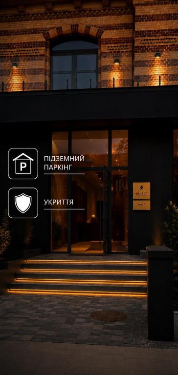 a building with a sign on the front of it at Апарт-готель Select in Lviv
