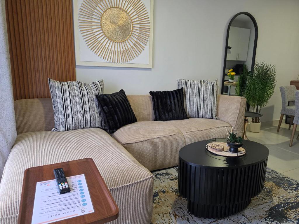 a living room with two couches and a table at Galani Homes Comfort 2-Bed Suite in Gaborone