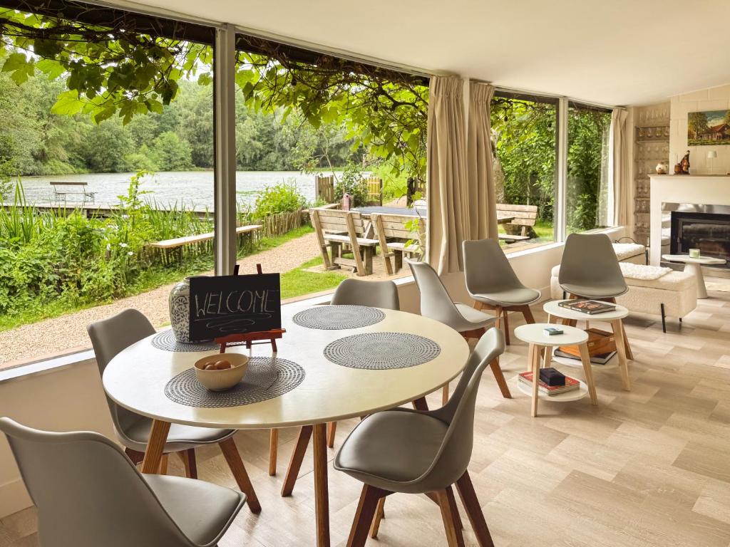 a living room with a table and chairs at Charming chalet with Pond in Kortessem in Tongeren