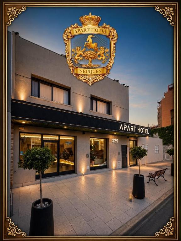 a hotel with a sign on the side of a building at Apart hotel in Neuquén