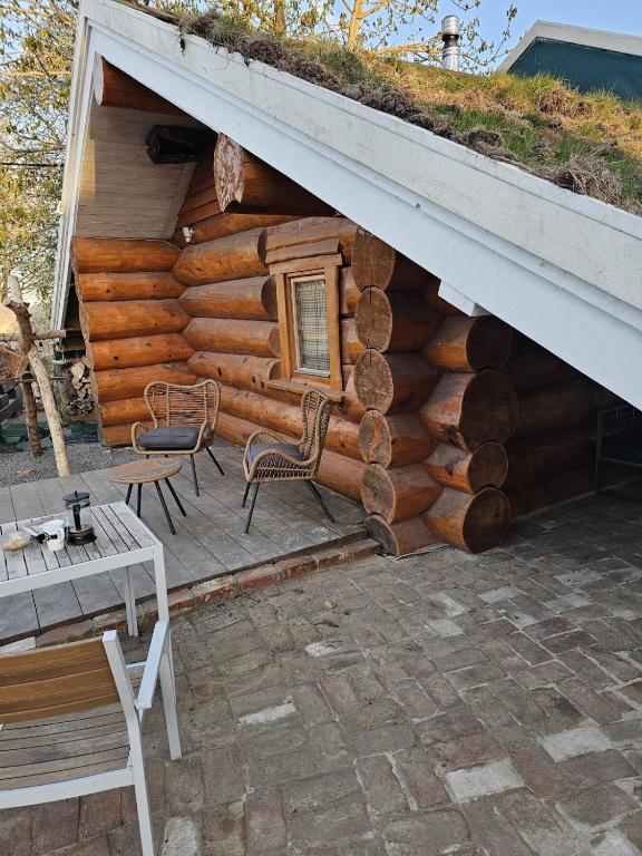 a log cabin with a bench and a table at Eco Retreat Saunahaus in Putgarten