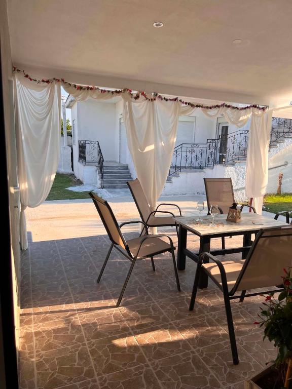 a patio with two chairs and a table and a table and a table and chairs at Villa Harmony in Xanthi