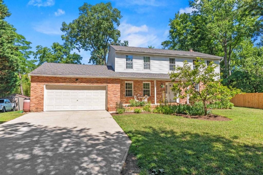 a brick house with a garage in a yard at Spacious Edgewater Home Deck & Sleeps 10 in Edgewater