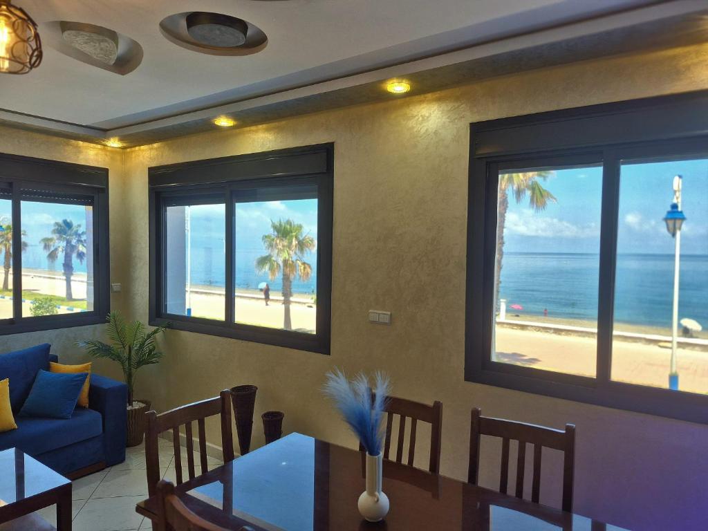 a dining room with a view of the beach at Beachfront First floor mekad in Oued Laou