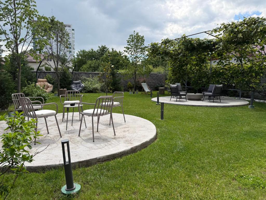 a group of chairs and tables in a yard at AFI Apartments & Rooms with GARDEN and FREE PARKING, Self check-in in Suceava