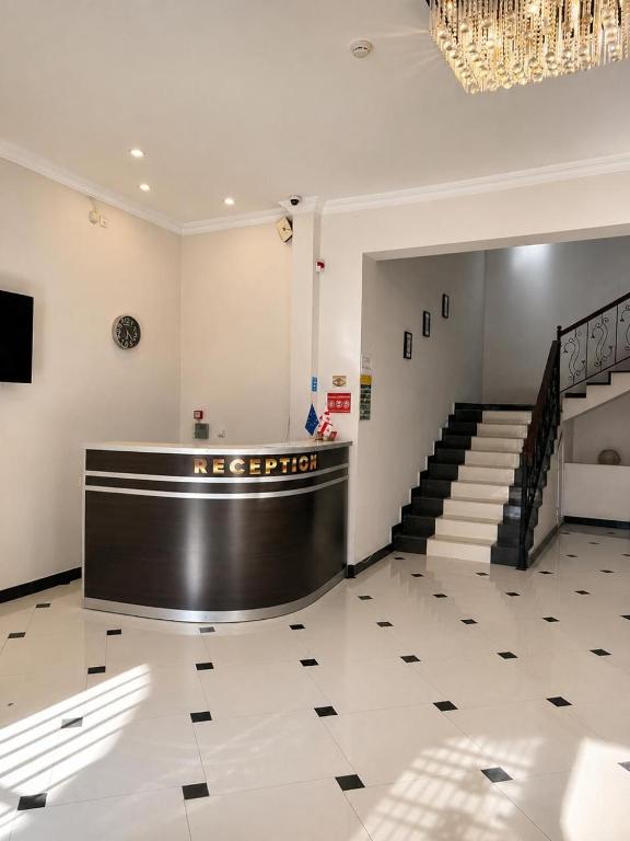 a large lobby with a staircase and a chandelier at Renesans Hotel Kobuleti in Kobuleti
