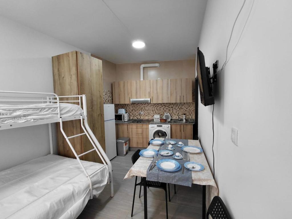 a small room with a table and a bunk bed at Rua de Galicia 1 in Ribeira