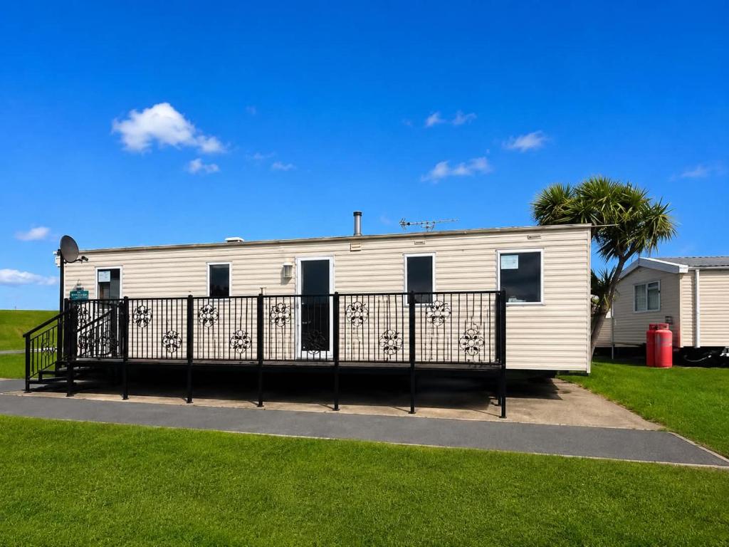 a white mobile home with a black fence at 7 Jay Valley in Bridlington