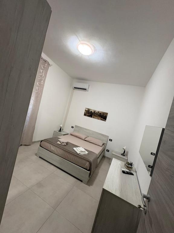 a bedroom with a bed and a table at Giusi home in Cologno Monzese